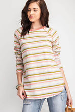 Woman wearing colorful pink-green-gray striped long sleeve top front.