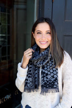 Woman wearing Panache black and grey snake skin pattern scarf with frayed hemlines front.