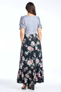 Woman wearing plus size modest style maxi dress with light blue lace bodice and floral pattern skirt with ruffled hem back.