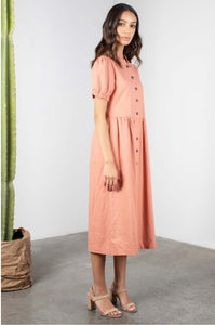 woman wearing dusty pink button down midi modest dress with sleeves side.