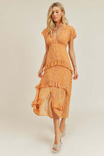 Orange midi dress styled with heels and clutch for summer event