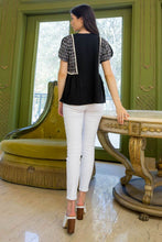 Woman wearing black knit tweed short split short sleeve THML top back.