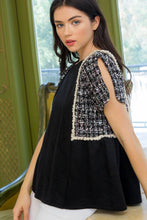 Woman wearing black knit tweed short split short sleeve THML top side.