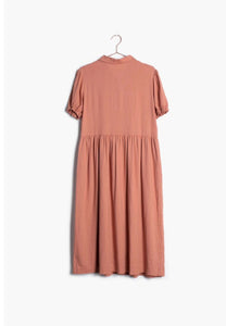 Dusty pink button down midi modest dress with sleeves hanging on hanger back.