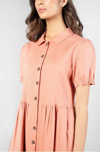 woman wearing dusty pink button down midi modest dress with sleeves front. 