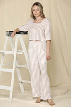 Woman wearing two piece brown and cream stripe shirt and pants summer set front.