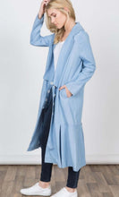 Women's light blue duster length jacket with pockets side.