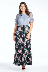 Woman wearing plus size modest style maxi dress with light blue lace bodice and floral pattern skirt with ruffled hem front.