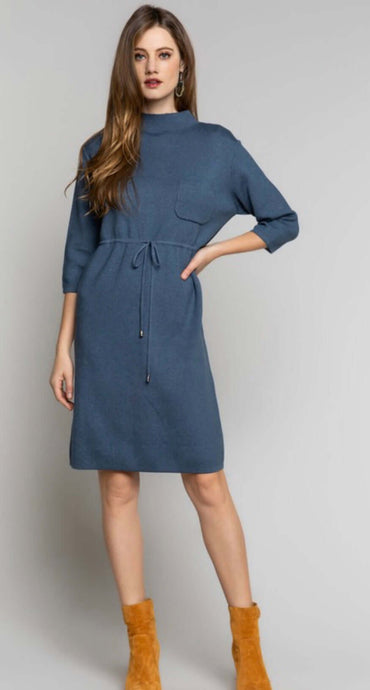 Women's blue sweater minidress with mock neckline, front pocket, and tie front detail front.