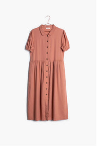 Dusty pink button down midi modest dress with sleeves hanging on hanger front. 